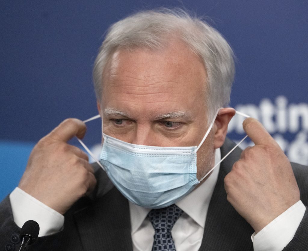 Quebec interim health director Dr. Luc Boileau removes his mask 