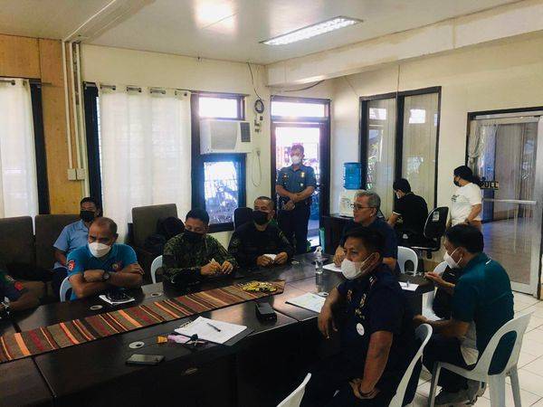 A group of uniformed men having a meeting