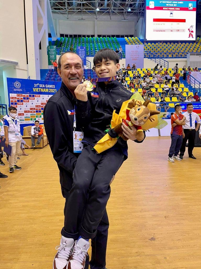 Ramon Fernandez carries Carlos Yulo