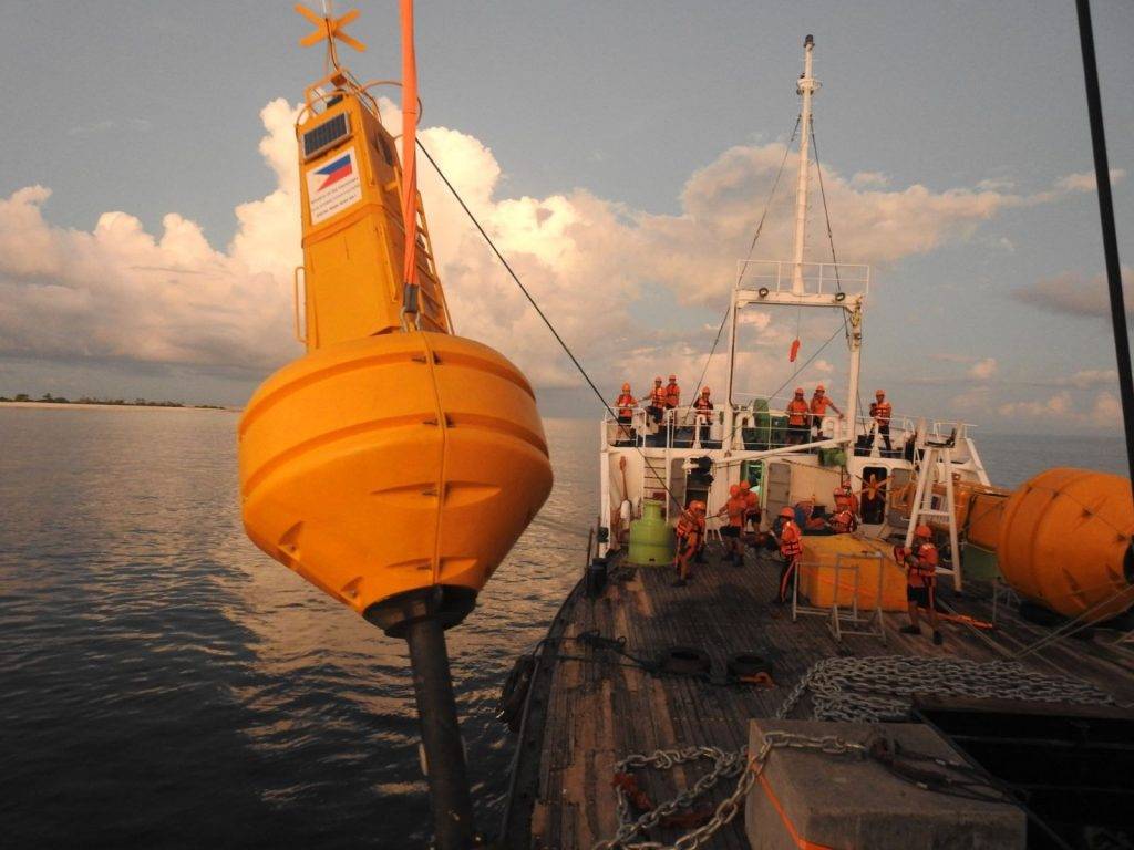 Yellow navigational buoy at sea