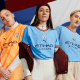 3 ladies wearing ETIHAD shirts