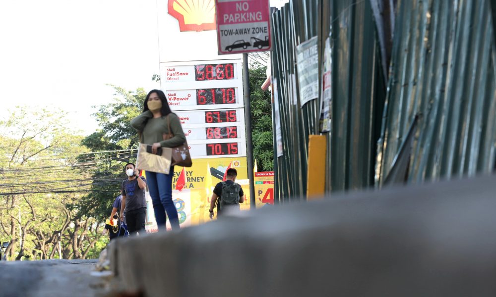 People standing near gasoline station