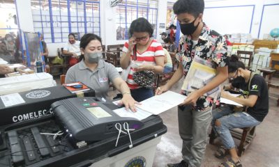 Voter inserting his ballot into the vote counting machine
