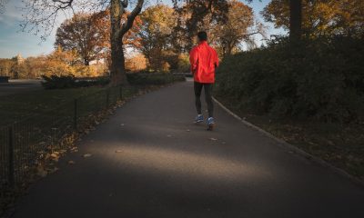Man in orange jogging in an empty road