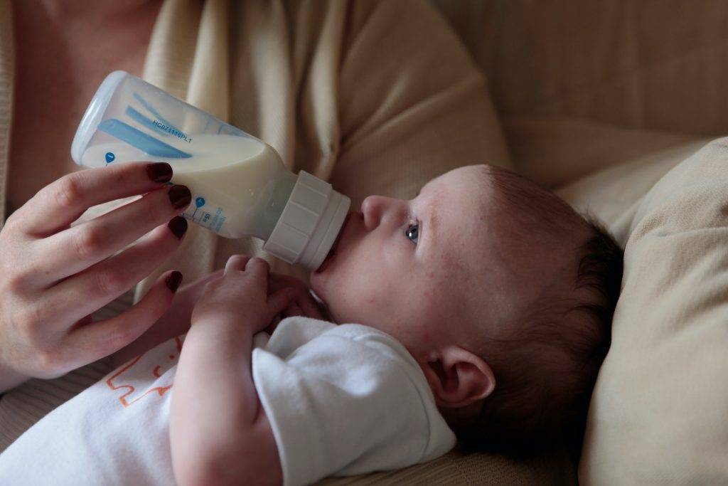 baby drinking milk from bottle