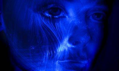 Futuristic light painting of a woman portrait, veins of fibre optic light passing through her face.
