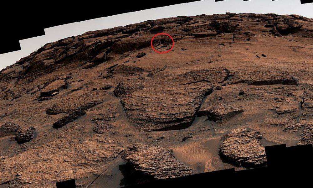 A panorama stitched together from about 100 individual Curiosity images. The ‘door’ is circled, and is tiny and hard to see at this scale.