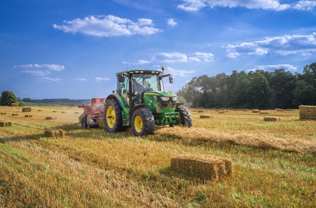 green tractor on brown grass