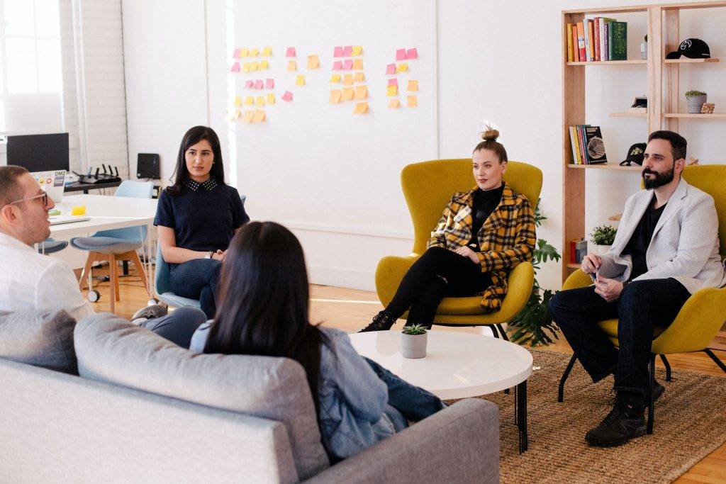 group of people in circle form talking