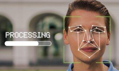 A man's face with facial recognition technology with the word "Processing"