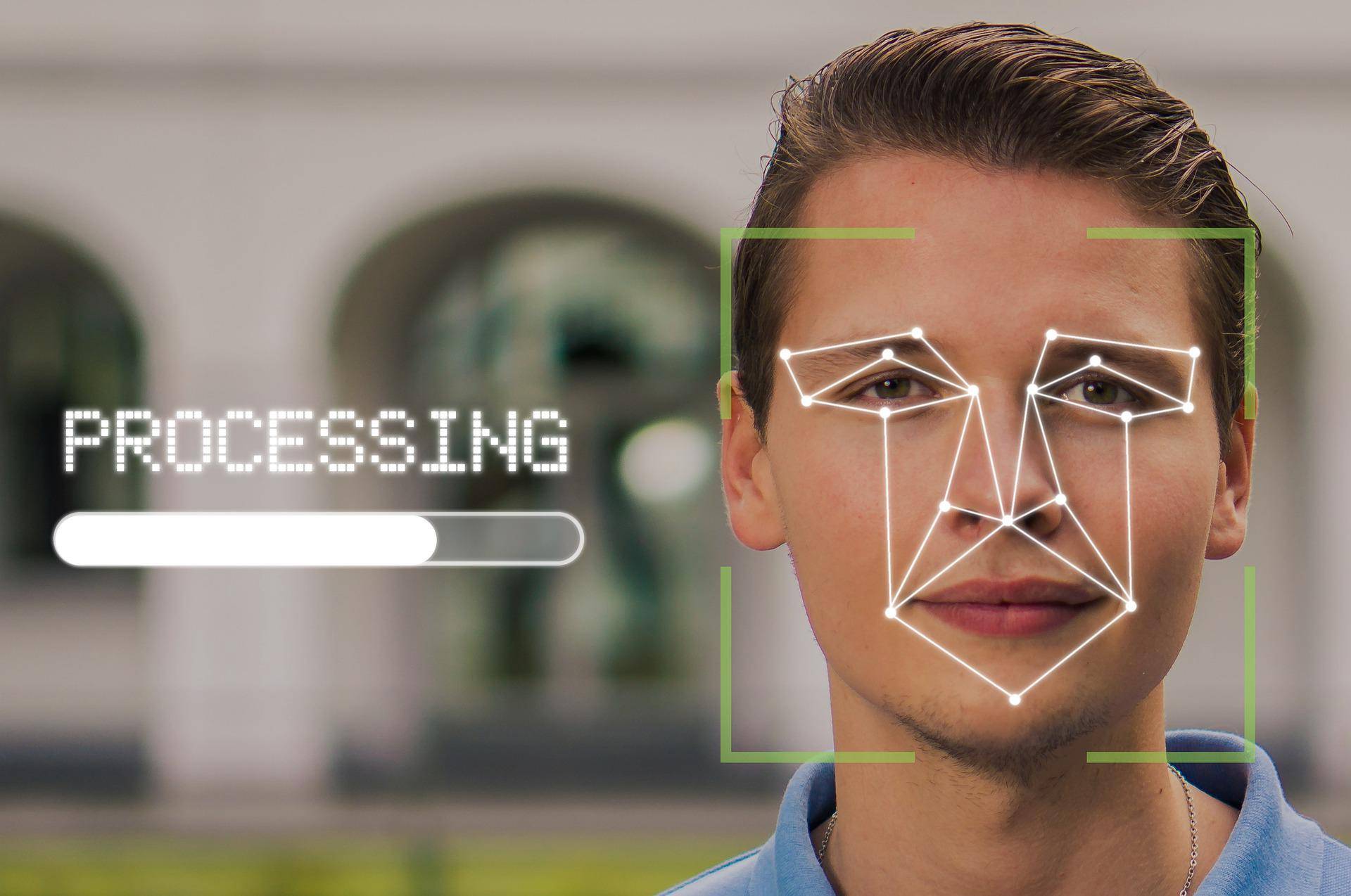 A man's face with facial recognition technology with the word "Processing"