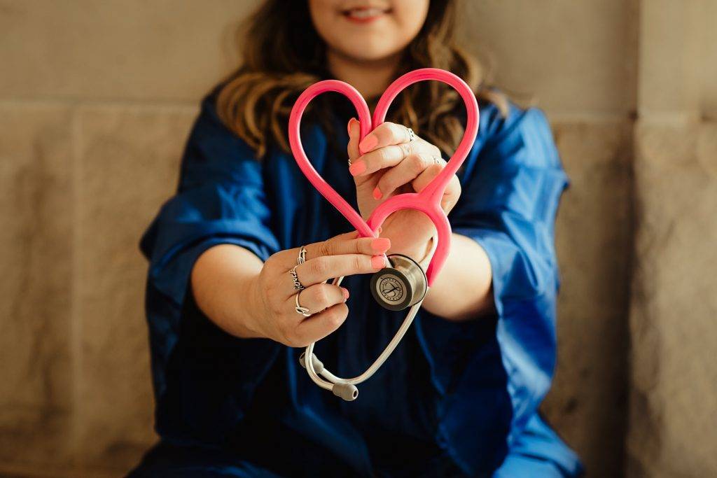 girl in blue holding stethoscope