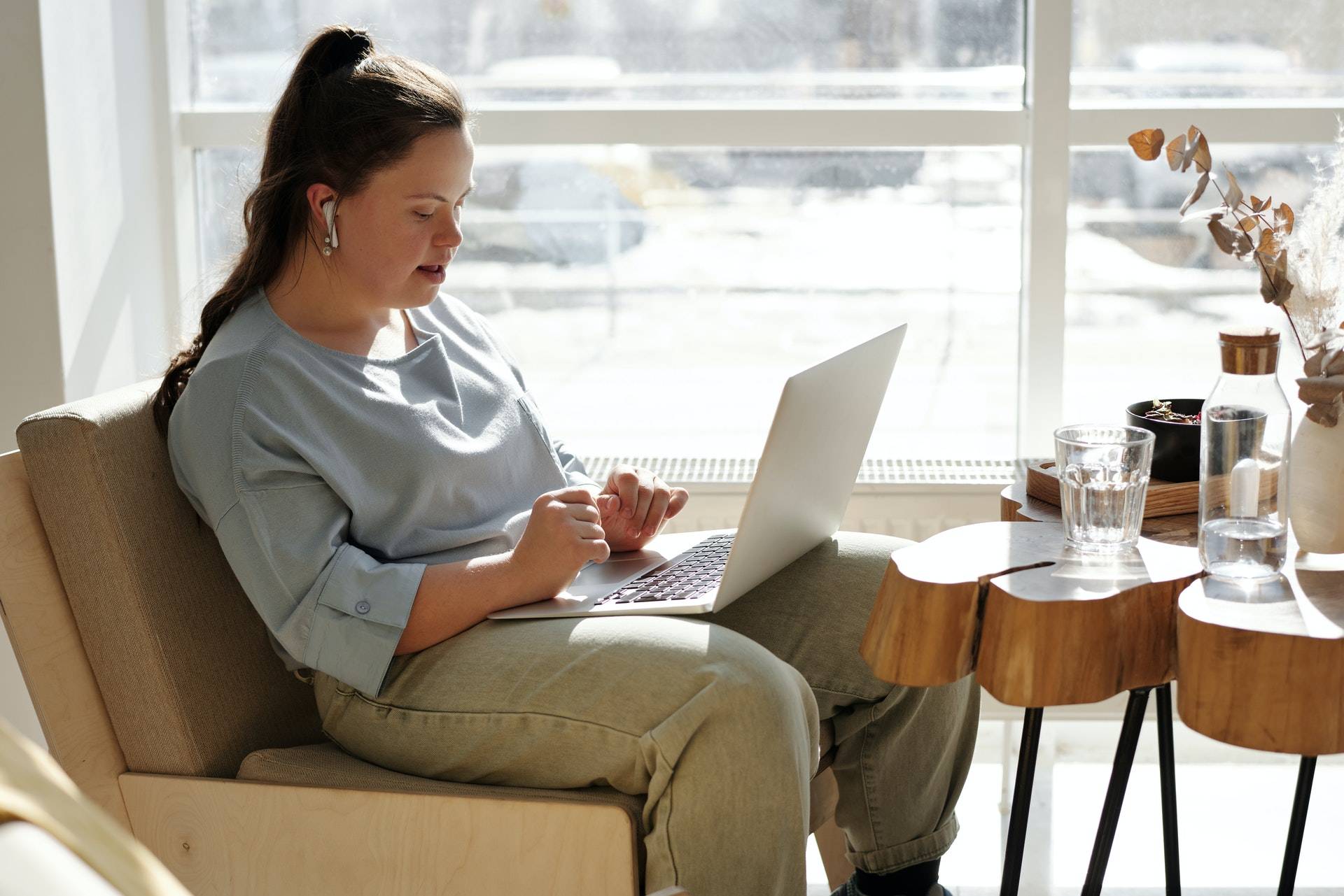 girl sitting on a couch with a laptop