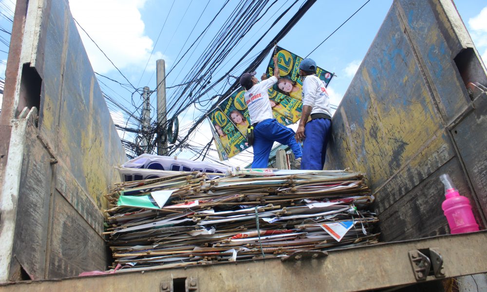 village personel removing campaign materials