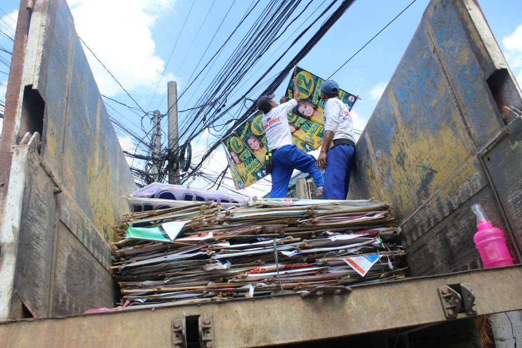 village personel removing campaign materials