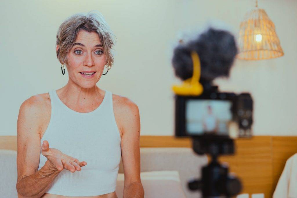 woman speaking in front of a camera