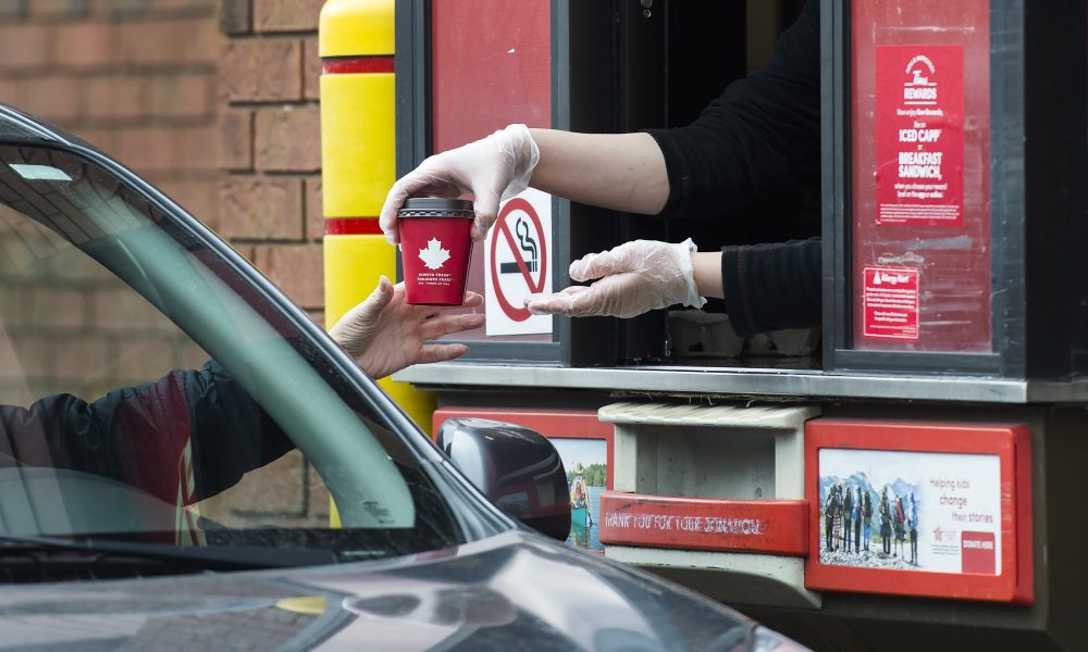 A cup being given in the drivethru service of Tim Hortons
