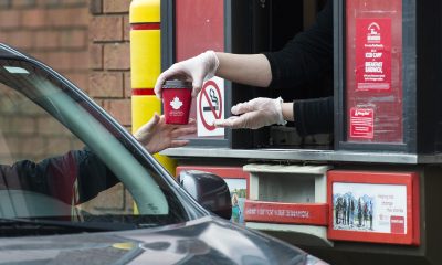 A cup being given in the drivethru service of Tim Hortons