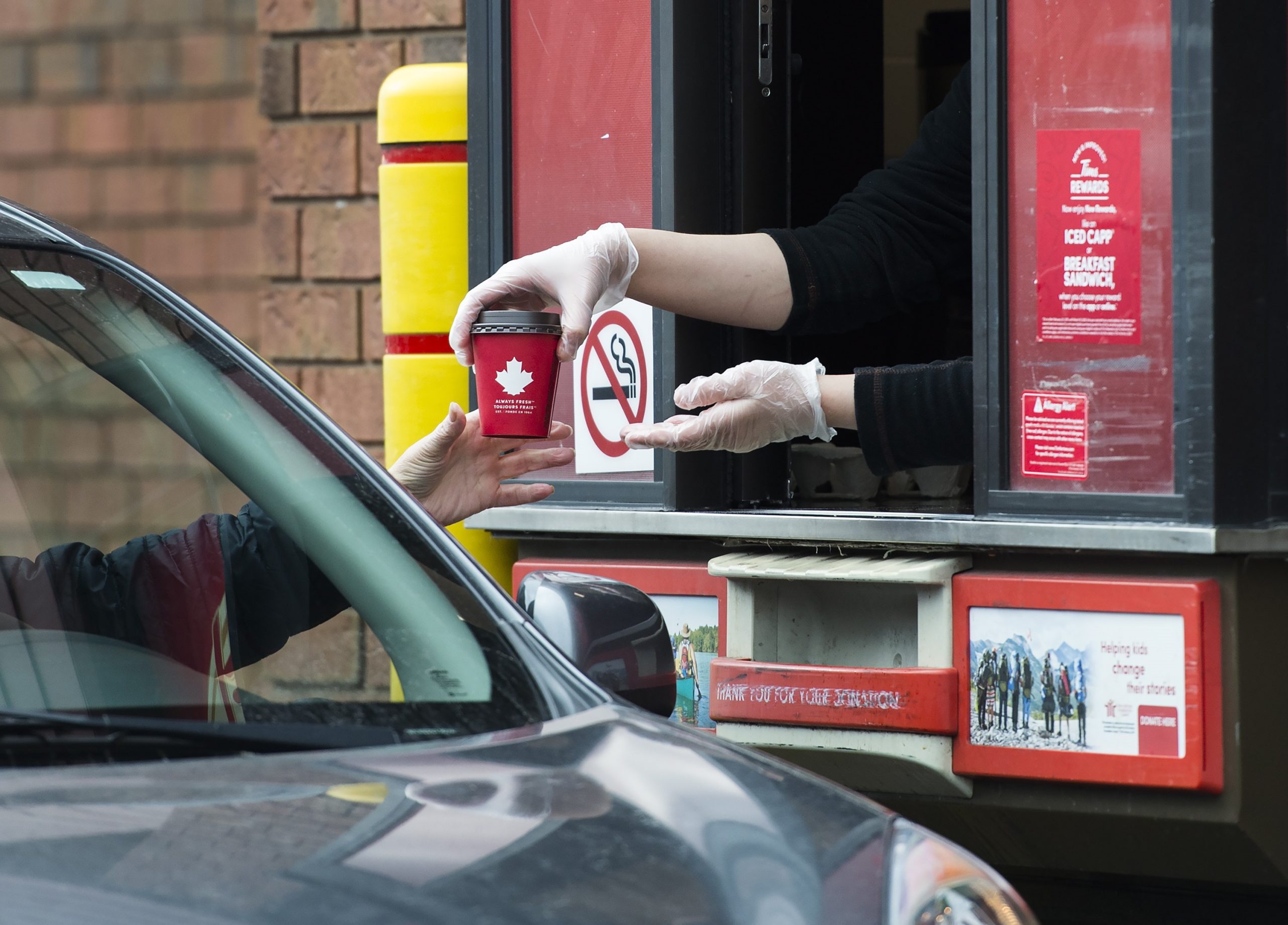 A cup being given in the drivethru service of Tim Hortons