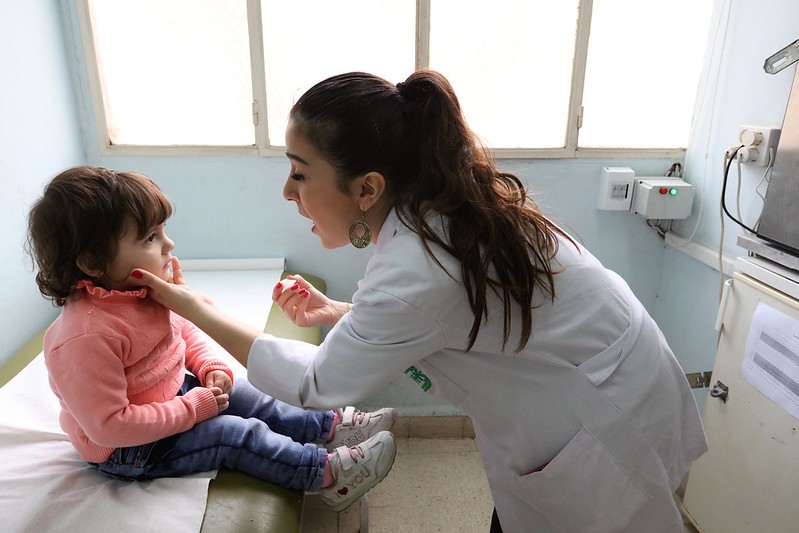 Registered nurse vaccinates a child for polio