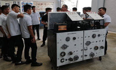 Men surrounding a box invention