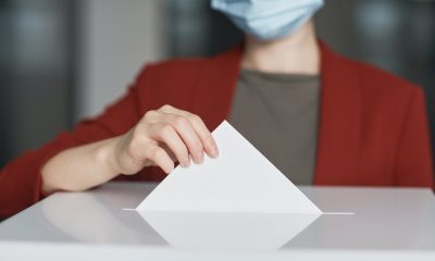 Ballot Box with Person Casting a Vote