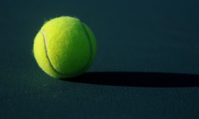 Tennis ball on dark green surface