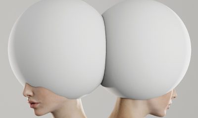 Identical persons with white round ornament on their heads