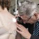 A doctor inspecting a woman's back with moles