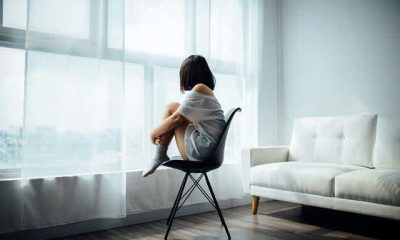 Girl sitting on a chair facing the window