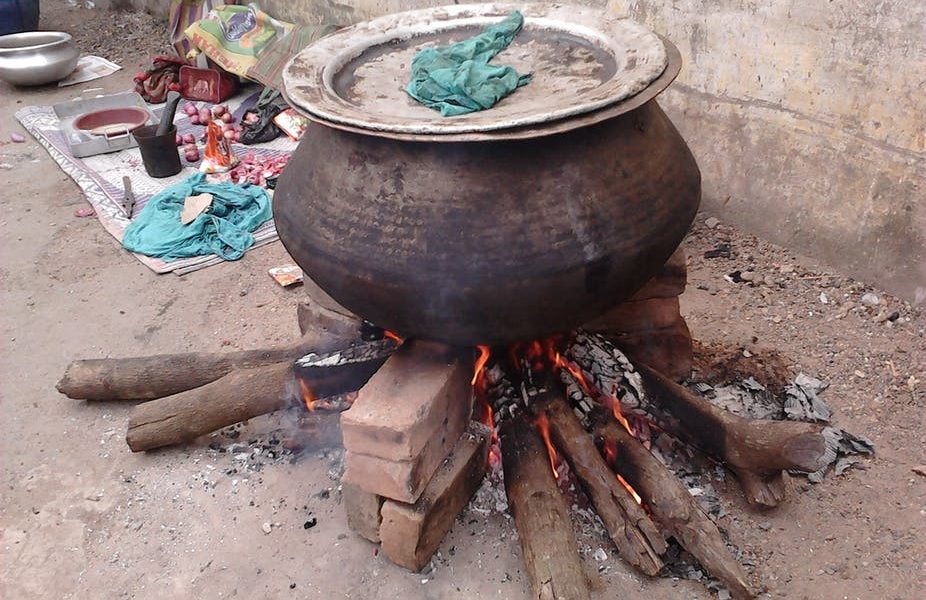 Pot on lit firewood
