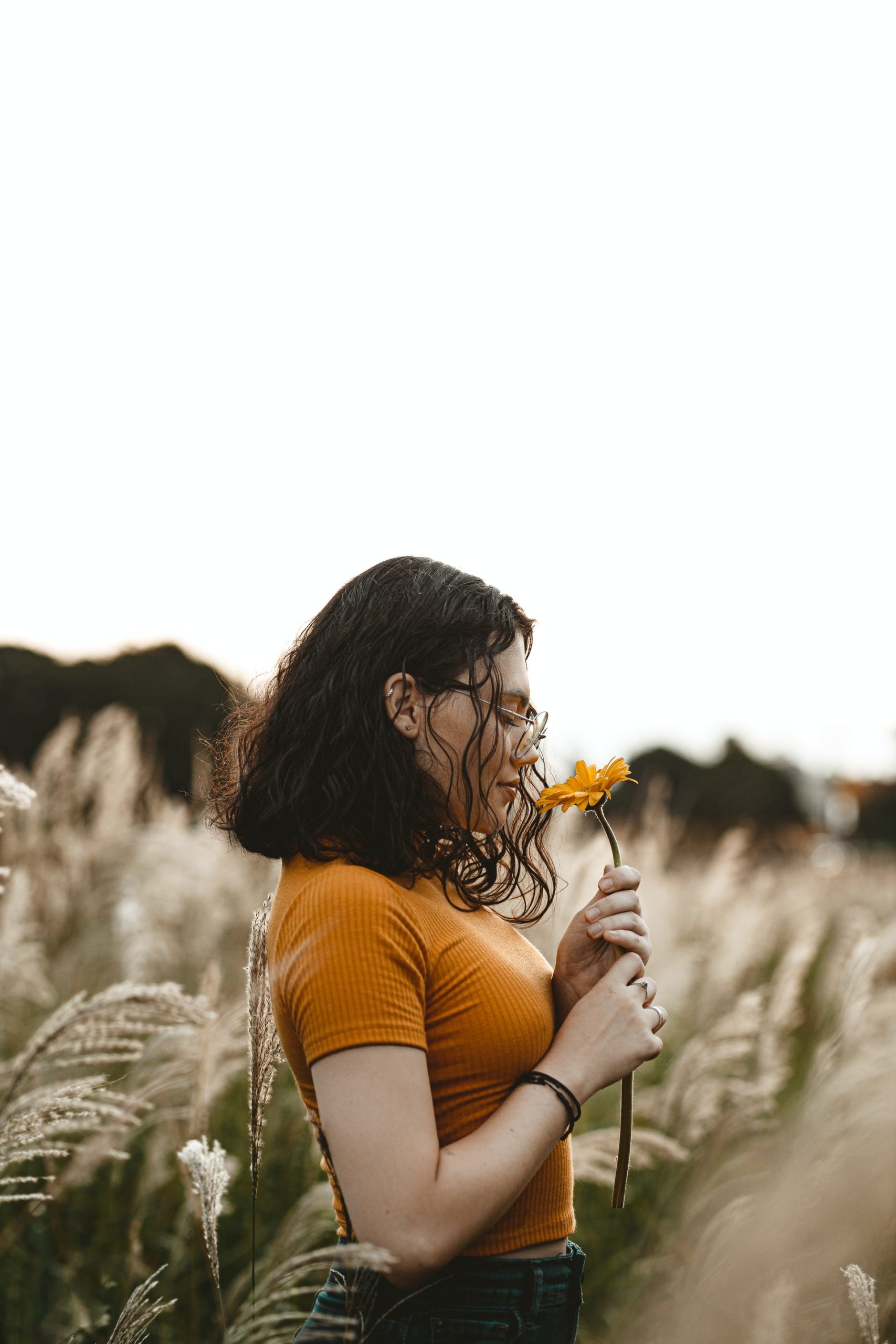 a girl smelling a flower