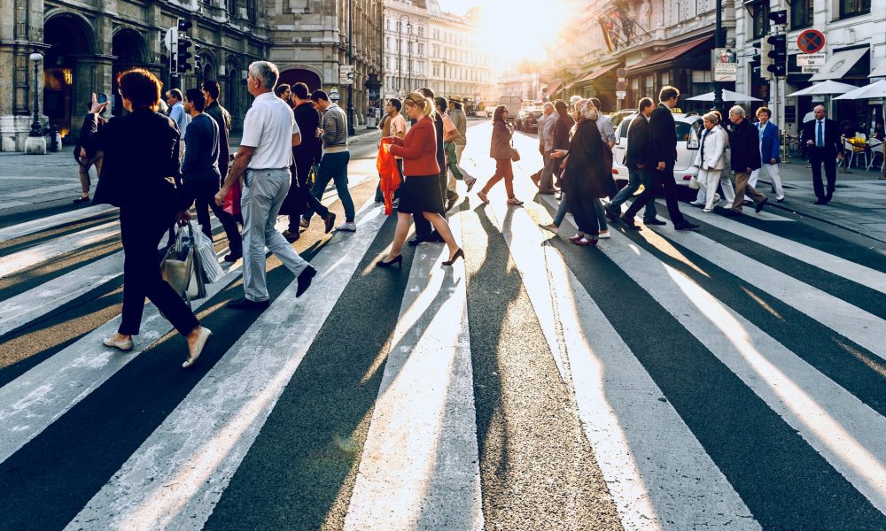A crowd of people walking on the pedestrian lane