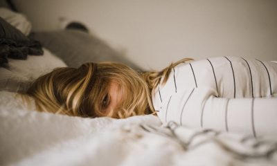 Woman lying awake on bed