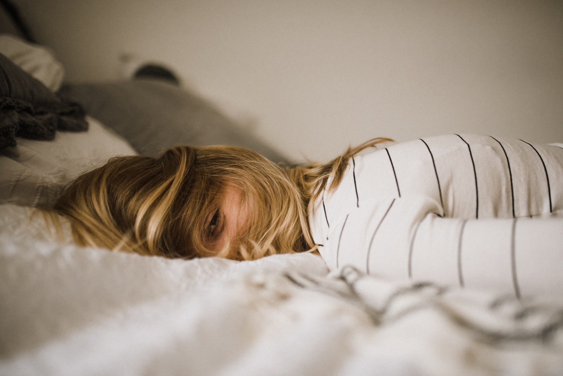 Woman lying awake on bed