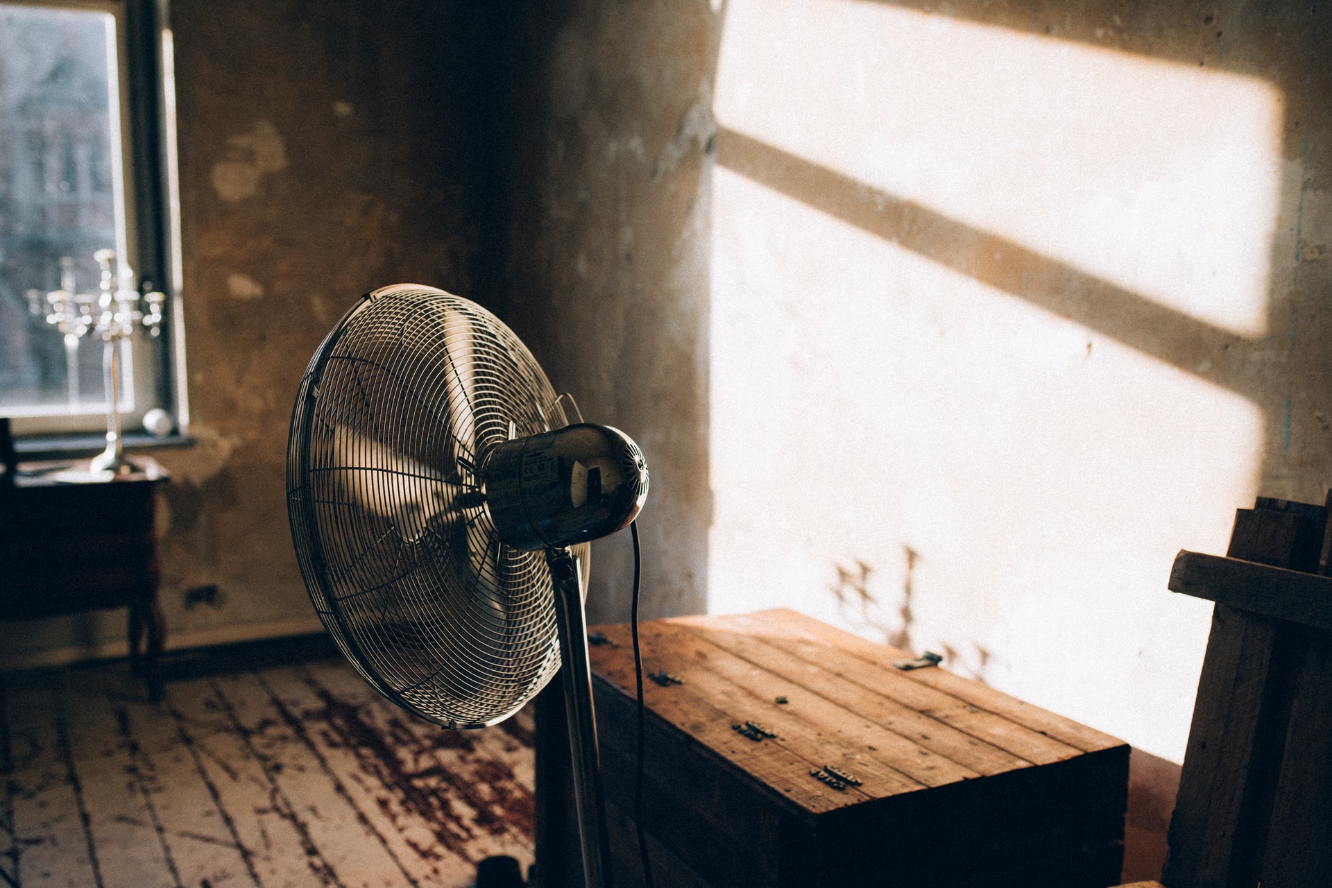 Electric fan in a sun-lit room