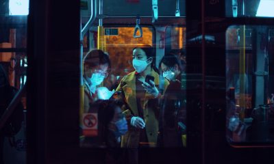 passengers inside a bus are wearing masks