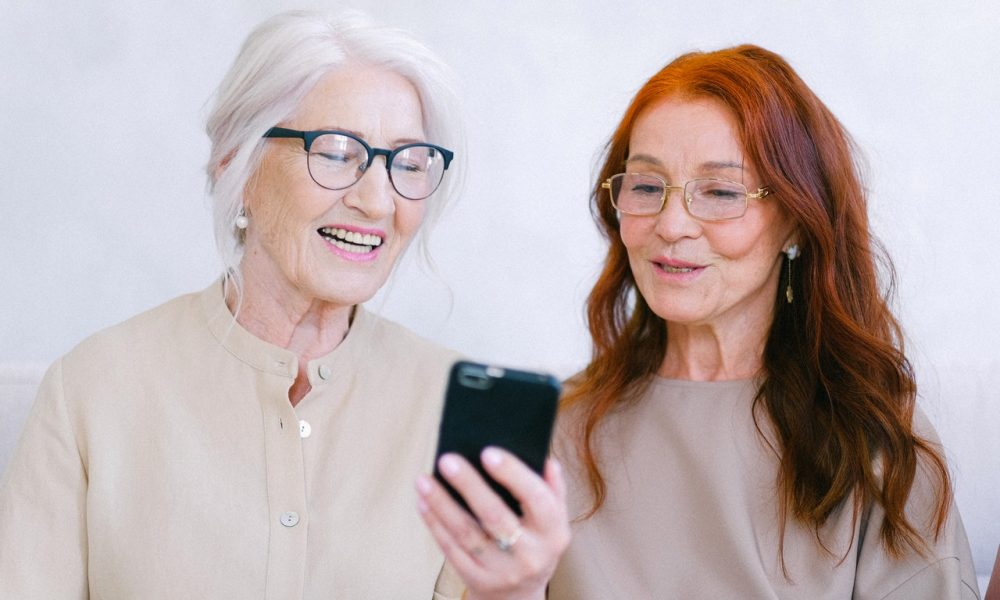 two elder women watching a video on a mobile phone