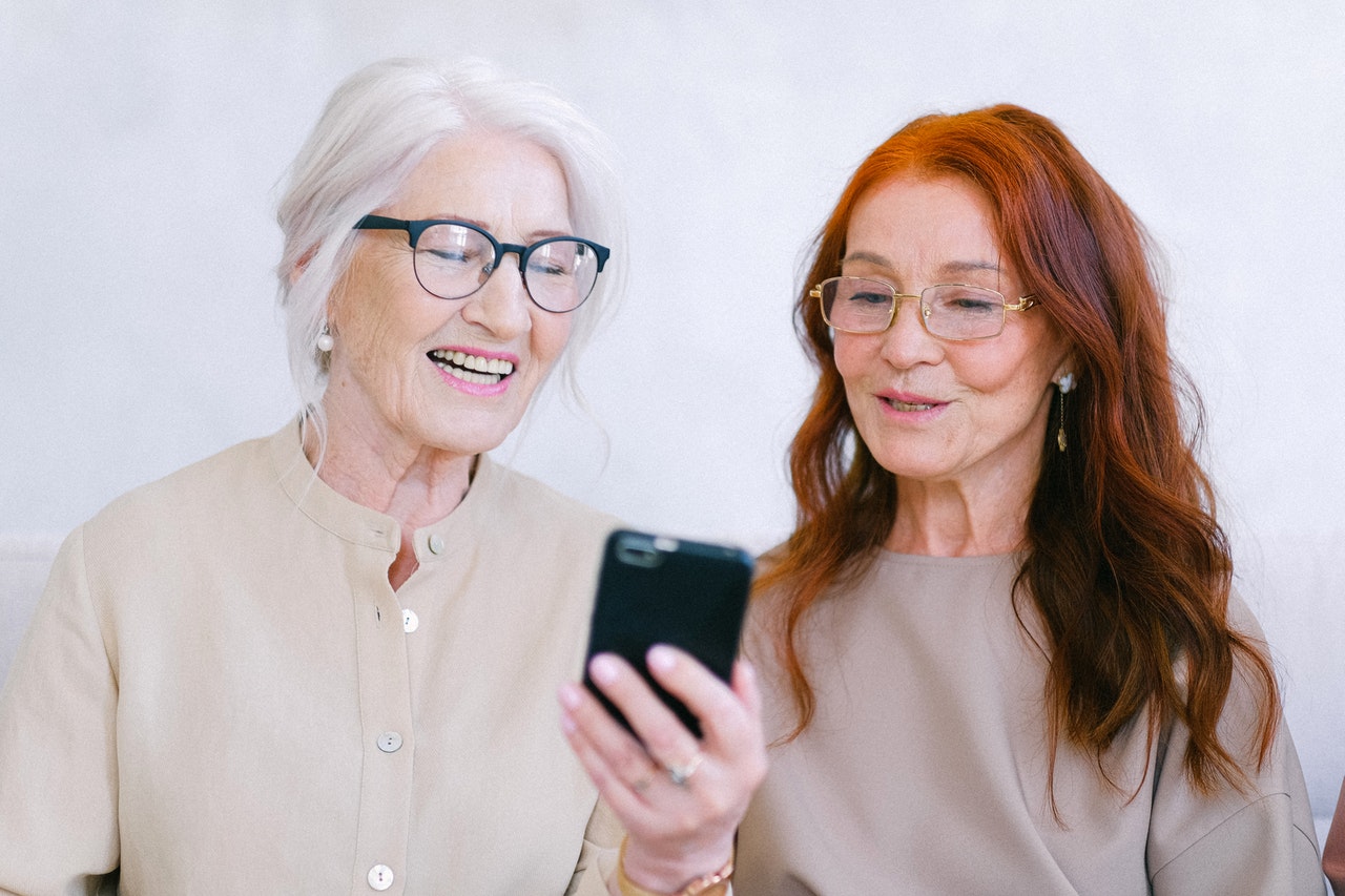 two elder women watching a video on a mobile phone