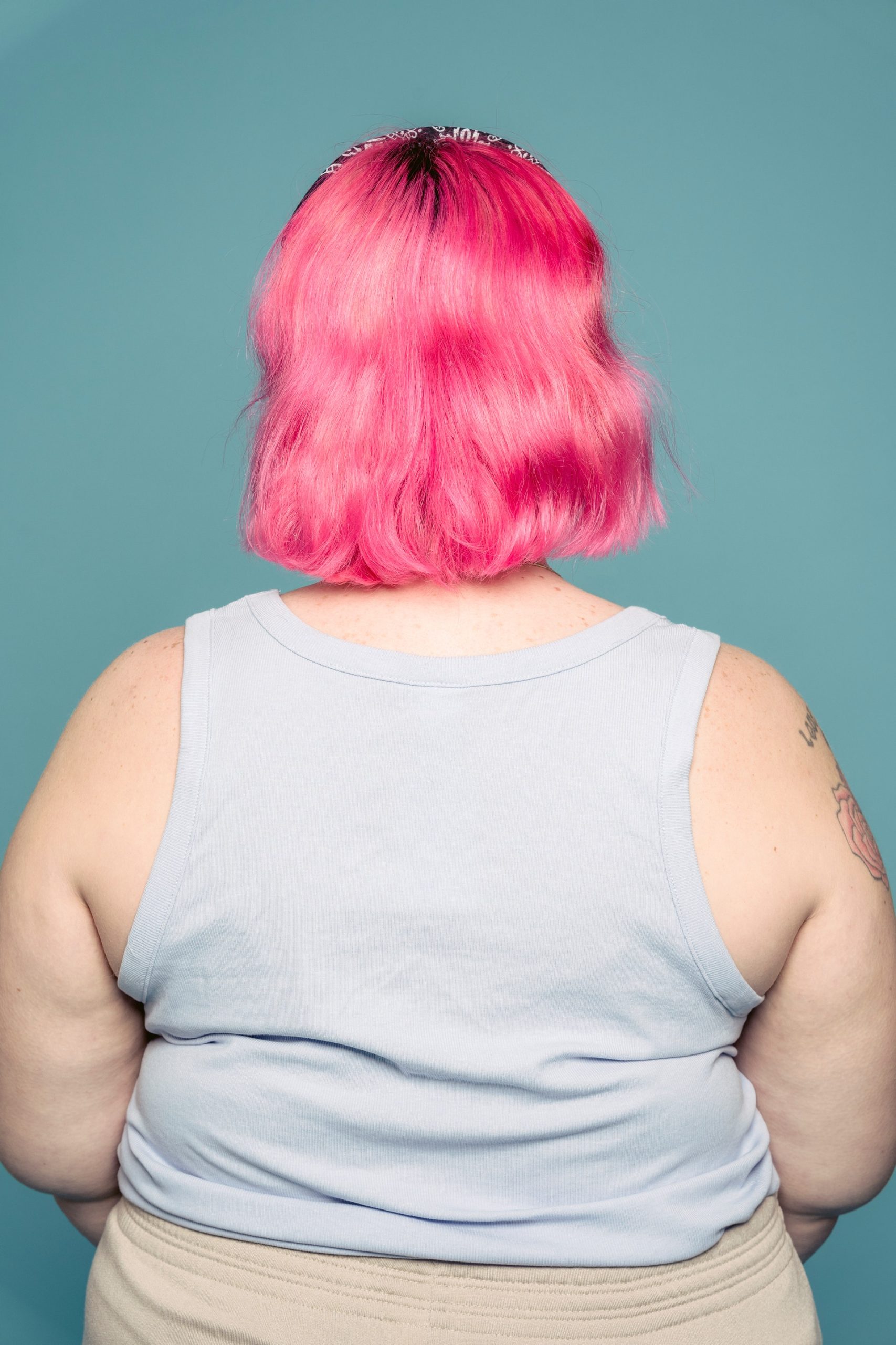 A woman with pink hair on her back