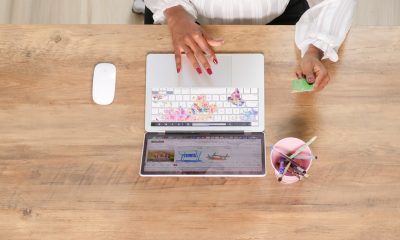 lady working on laptop and holding a card