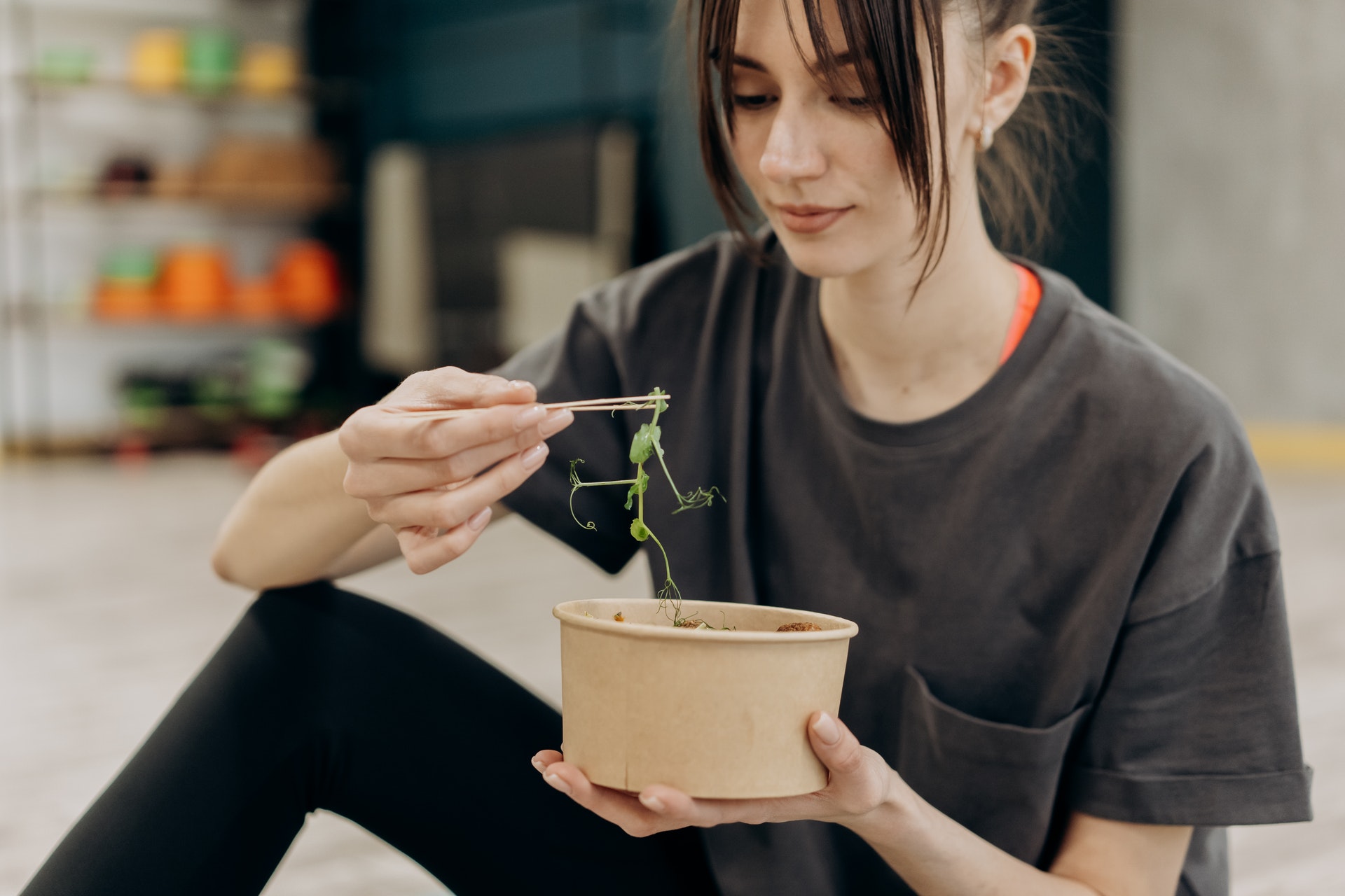 Girl picking up a veggie from her meal