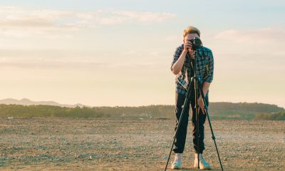 guy taking picture in an open field