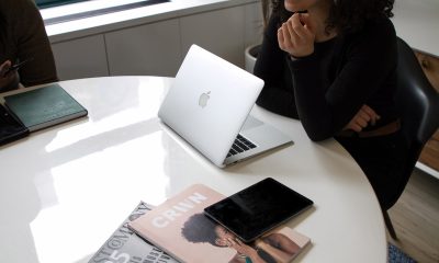 Meeting on table with laptop and magazines