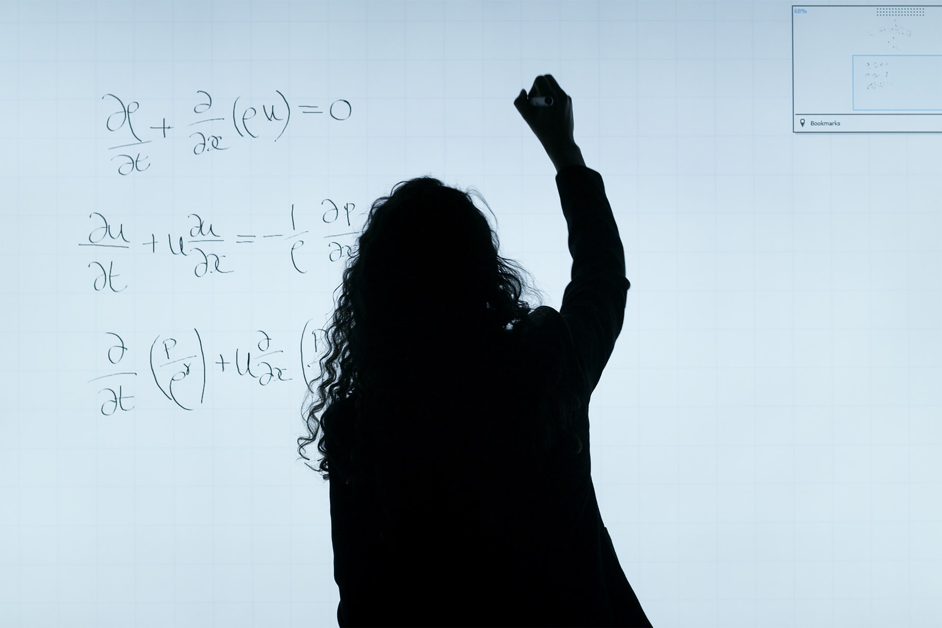 woman solving math equation on board