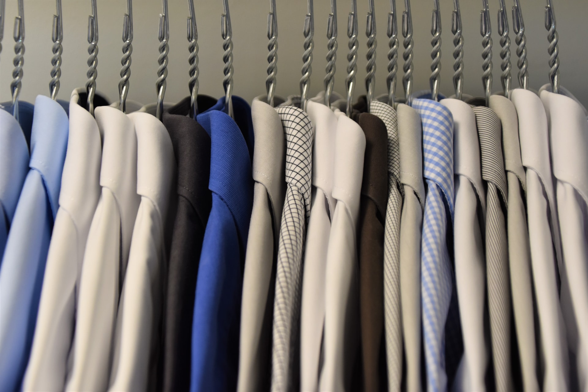 Assorted colored dress shirts hung