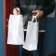 A Person Holding Paper Bags