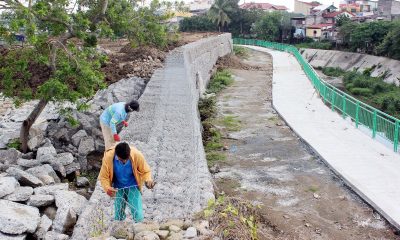 Construction workers installing a gabion