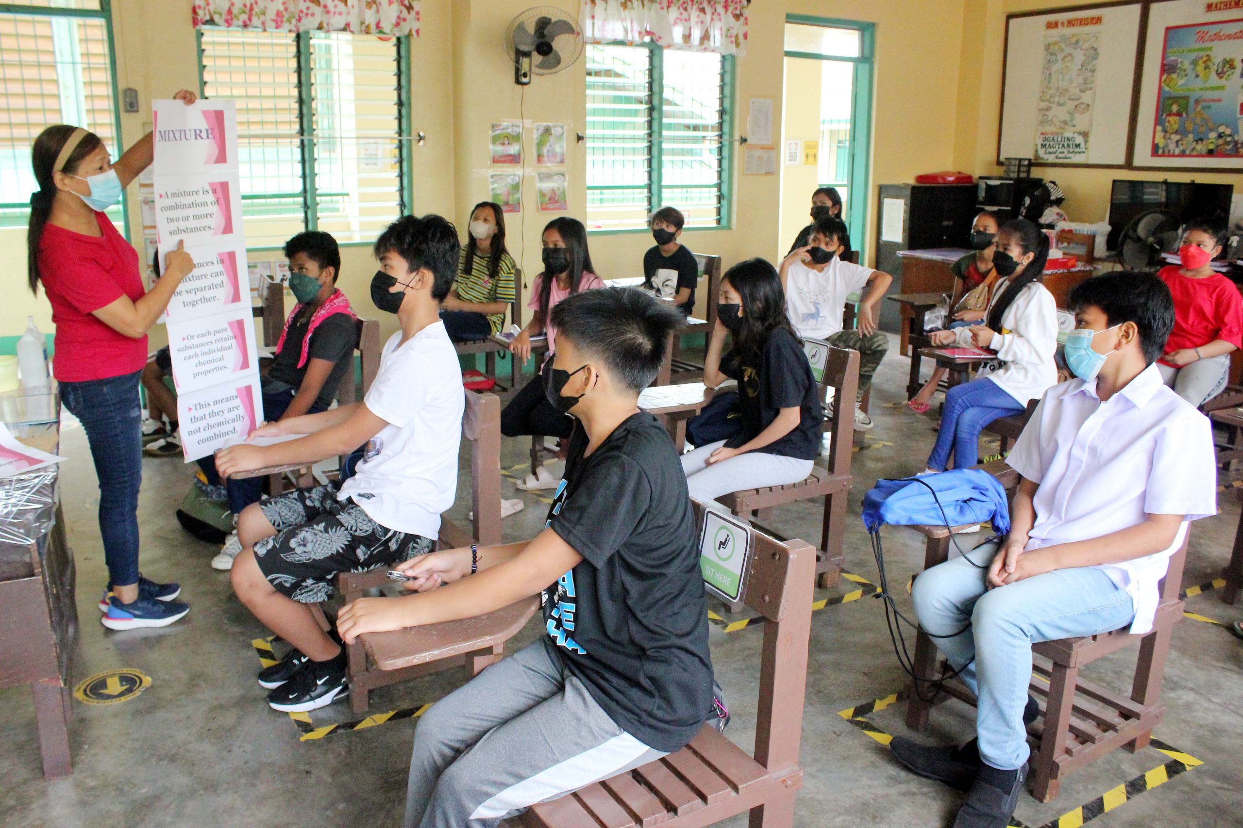 Grade 6 students listen to their teacher