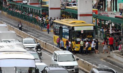 Passengers board a bus at the Edsa Carousel busway